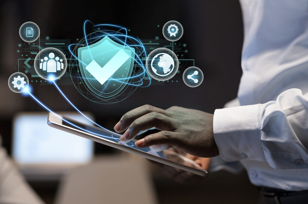 a black male hand scrolling on a device which pops up symbols showcasing security data